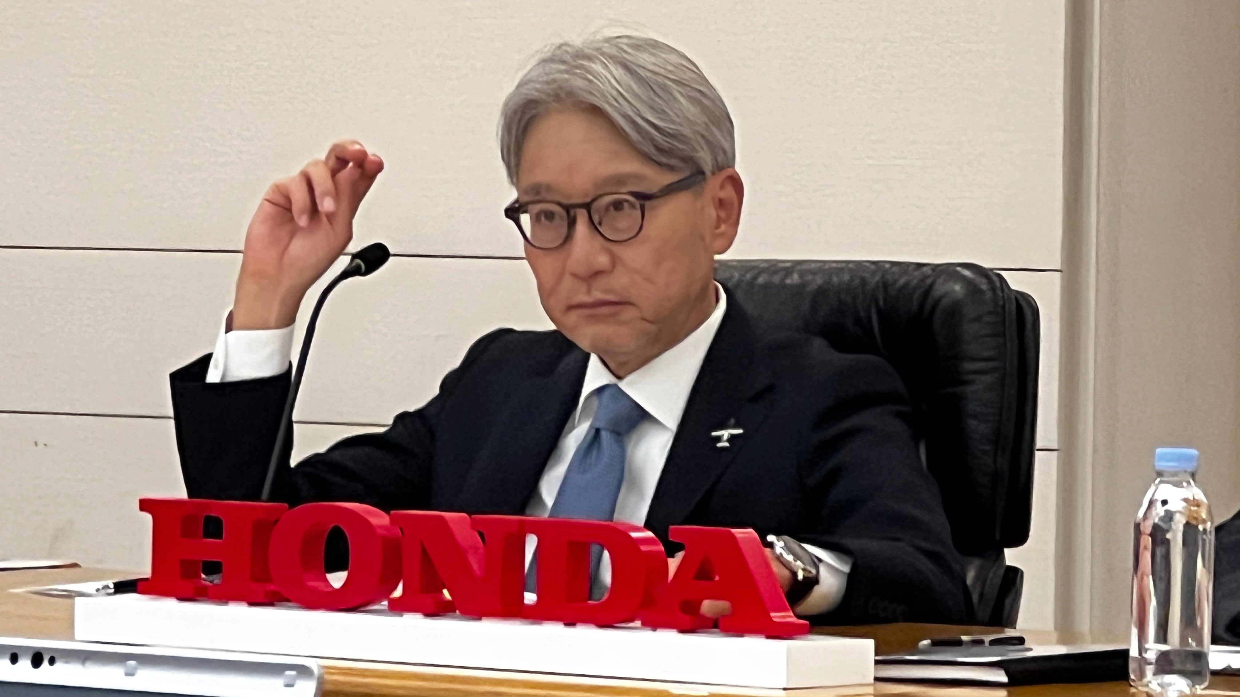 Honda CEO Toshihiro Mibe, seen here giving a business plan update May 20, 2025, in Tokyo, says the company will scale back investment in EVs and focus on hybrids instead.